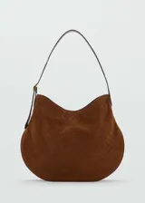 Bolso tipo hobo de gamuza color marrón con patrón de logo estampado. Tiene asa de hombro ajustable con hebilla dorada y cierre magnético.