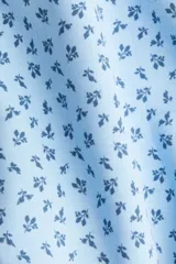 Short pollera mini de tejido suave con efecto neopreno, color celeste con estampado floral en azul oscuro. Modelo ajustado con elástico oculto en la cintura y nesgas que aportan volumen.