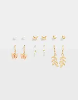 Set de seis pares de aros dorados con diferentes diseños: perlas, mariposas, corazones y hojas.