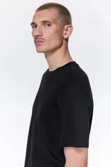 Remera negra de algodón con cuello redondo y corte estándar.