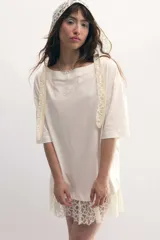 Remerón blanco de cuello bote con encaje integrado y bordado del monograma de la marca a tono. De calce holgado, confeccionado en malla fina compactada y prelavada.