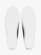 Zapatillas Tommy Hilfiger de lona negra con suela blanca de goma y talón dorado metalizado.