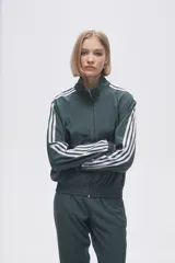 Campera deportiva verde con cierre frontal, cuello alto y tres rayas blancas en las mangas.