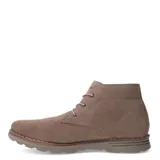 Botas tipo chukka de gamuza color taupe, con cordones y suela de goma gruesa. Presentan costura visible alrededor de la base y el logo de la marca grabado en el lateral.