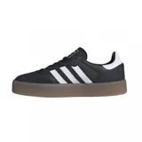 Zapatillas Adidas Samba con plataforma, color negro con las tres tiras blancas y suela marrón.