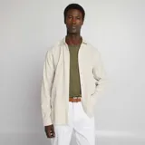 Camisa beige con rayas verticales finas, de corte clásico, manga larga y cuello camisero.