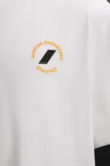 Camiseta blanca de algodón con corte relaxed fit, cuello redondo y manga corta. Estampado en el frente con un logo pequeño y en la espalda con un diseño de tablas de surf y texto.