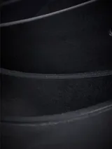 Cinturón de cuero negro con hebilla metálica de estilo envejecido.