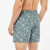Short de baño celeste con estampado de palmeras blancas.