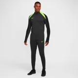 Pantalón largo de fútbol Nike Dri-Fit Strike para hombre, color negro con logo verde neón y detalles en verde neón en la parte inferior de las piernas.