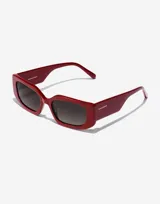 Lentes de sol Hawkers modelo Trendset, con montura rectangular de color rojo marmolado y lentes negras.