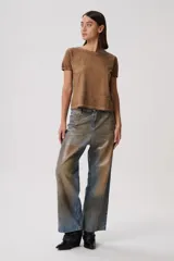 Pantalón de jean azul con estampado de zorros en tonos marrones.