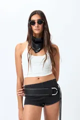 Microshort de tiro bajo color negro, con cierre metálico en la espalda, de calce ajustado y largo mini.