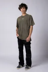 Remera negra con efecto gastado, corte holgado y estampa frontal con la frase 'Astral Energy' en blanco.