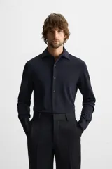 Camisa azul marino slim fit de manga larga con cuello italiano abierto y cierre frontal con botones.