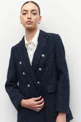 Blazer de tweed color azul marino con seis botones metalizados, de corte clásico y femenino.