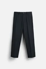 Pantalón de vestir azul marino, de corte recto, con bolsillos laterales y traseros. Incluye un bolsillo tipo cargo en la pierna izquierda. Se ajusta a la cintura con cinturón de cuero marrón.