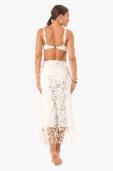 Falda midi de encaje blanco con abertura lateral y flecos en el ruedo.