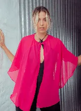 Capa corta color verde esmeralda de gasa transparente, con cuello redondo y abertura frontal con cierre de botón.