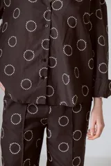 Camisa marrón con estampado de círculos blancos, cuello mao, manga larga y cierre frontal con botones.