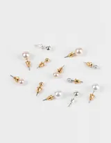 Set de seis pares de aros con perlas de distintos colores y tamaños, con plating de metal y cierre a presión.