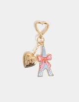 Llavero con gancho en forma de corazón dorado, dije de la Torre Eiffel esmaltada en celeste con un lazo rosa y dije de corazón dorado con diseño grabado.