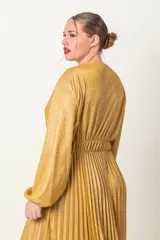 Vestido largo de lurex color dorado, con diseño cruzado y falda plisada de manga larga.