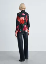 Camisa de manga larga con puños abotonados, cuello camisero, cierre frontal con botones y estampado floral sobre tejido fluido con acabado satinado.