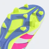 Championes de fútbol Adidas Predator Club FG/MG, color blanco con detalles en rosa y amarillo. Presentan las tres tiras características de la marca en color rosa. Suela con tapones para terreno firme y pasto sintético.