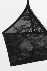 Bralette triangular negro de encaje con tirantes finos ajustables.