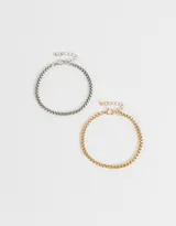 Set de dos pulseras flexibles con cadena de eslabones cuadrados, una plateada y otra dorada.
