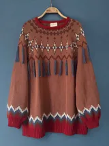 Sweater tejido en intarsia con algodón color marrón, con cuello redondo, mangas abullonadas, silueta holgada y tajos laterales.