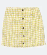 Falda corta de tweed con cierre frontal de botones.
