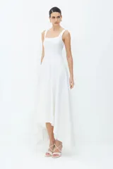 Vestido midi blanco de algodón compacto con corte entallado y bajo ancho. Presenta cortes asimétricos en el bajo, escote recto, cremallera de nailon en la espalda y tirantes anchos.
