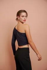 Top corto negro de un hombro con manga larga ajustada.