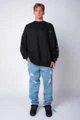 Buzo negro de corte oversize con cuello redondo y mangas largas. Presenta un pequeño logo estampado en el pecho y un diseño de empanadas y textos en la manga.