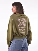 Buzo deportivo color verde oliva con cuello polo y puños ajustados.