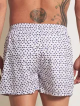 Bóxer de algodón con estampado floral en tonos azul y blanco, con cintura elástica y logo de la marca en el centro.