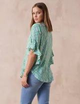 Blusa de gasa estampada con cuello a la base, abertura central con botones y mangas cortas con volados.