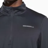 Buzo gris de poliéster reciclado y spandex, con cuello alto y cierre de cremallera hasta el pecho. Tiene mangas largas con orificios para los pulgares y logo de la marca en el pecho.
