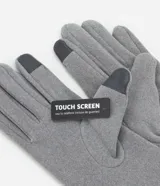 Guantes grises de poliéster y poliuretano, con detalle touch screen en uno de los dedos.