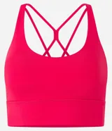 Top deportivo alargado color rojo, confeccionado en microfibra con escote en U, tiras finas cruzadas en la espalda y cintura ancha. Incluye copas removibles.