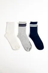 Pack de tres pares de medias deportivas de caña media. Incluye un par blanco liso, un par gris melange con dos franjas azul marino en el borde superior, y un par azul marino con dos franjas blancas en el borde superior.