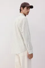 Camisa de manga larga con cuello inglés, a rayas verticales grises y blancas, con bolsillo en el pecho.