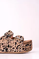 Sandalias con plataforma de corcho, con estampado animal print en tonos beige y negro, y hebillas metálicas plateadas.