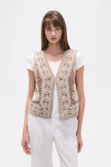 Chaleco sin mangas color marrón topo, con escote en V y bordados intrincados en color crema/blanco que cubren toda la prenda.