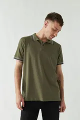 Chomba azul marino de manga corta con cuello polo y detalles de líneas grises en cuello y mangas. Tiene logo bordado en el pecho. Corte regular.