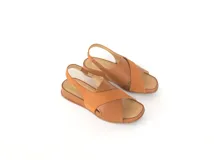 Sandalias color caramelo con tiras cruzadas, talón con elástico interno y plantilla de cuero acolchada.