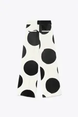 Pantalón de tiro medio confeccionado con hilatura en mezcla de viscosa y lino. Diseño con lunares grandes en blanco y negro. Pierna ancha con detalle de raya planchada. Cierre lateral con cremallera oculta en costura.