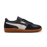 Championes Puma Palermo LTH de cuero negro con franja lateral blanca y suela de goma marrón.